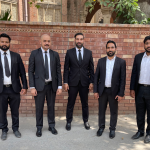 Young Pakistani lawyer standing outside court