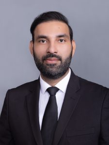 A lawyer in a suit with a beard.